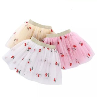 Sur fond blanc, on voit trois jupes en tulle imprimé cerise.