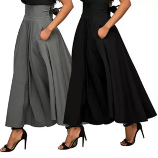 Photo de deux jeunes femme qui marchent le bras gauche plié la main dans la poche de la jupe qu'elles portent l'une grise et l'autre noire, jupe longue fluide avec une large taille